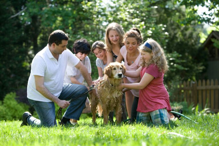 Familia sonriente en el jardín con su perro